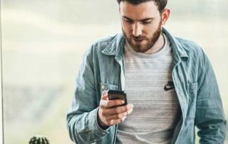 A man posting bail on his cell phone indicating who can post bail and the bail bond process of A-Affordable Bail Bonds in Washington State.