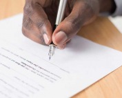 A close-up of a person signing a bail bond agreement at A-Affordable Bail Bonds in Vancouver, WA