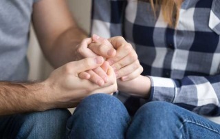 A man and woman holding hands representing needing bail bond services from A-Affordable Bail Bonds in Washington State